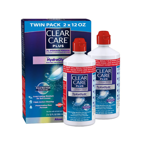 Two bottles of Alcons Clear Care Plus Cleaning Solution with Lens Case, Twin Pack (12 oz each), are displayed in front of their box, showcasing benefits such as 3% hydrogen peroxide cleaning, long-lasting moisture with HydraGlyde®, and a preservative-free formula.