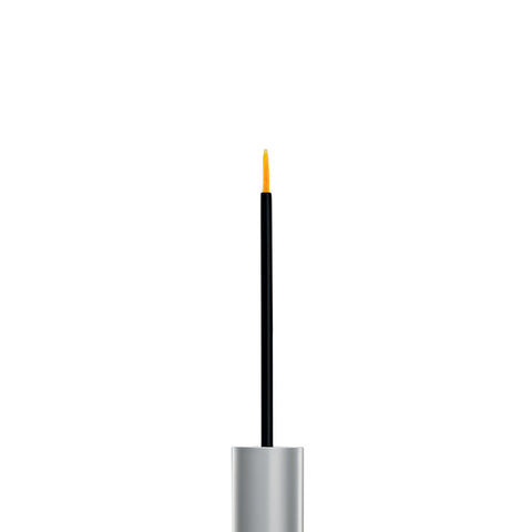 A tube of RevitaLash Advanced Eyelash Conditioner, open to show a thin brush with a yellow tip infused with BioPeptin Complex, stands upright in its sleek metallic design. This dual-function product by RevitaLash acts as both a liner and a lash serum.