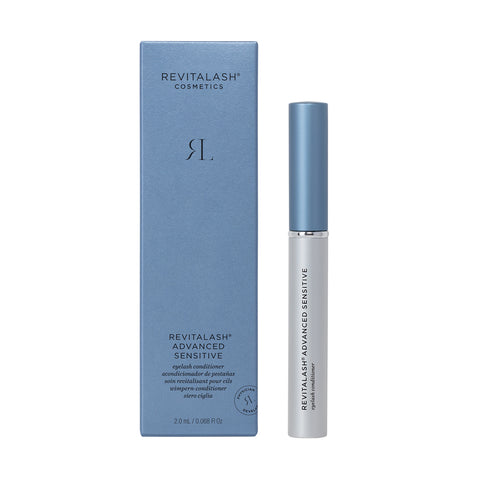 Image of RevitaLash Advanced Eyelash Conditioner and Enhancing Serum Sensitive (2.0mL 3 Mo.Supply), showing a blue box with white text and a sleek white tube capped in silver. The black label highlights RevitaLash Advanced Sensitive, emphasizing its gentle blend of peptides and botanicals.