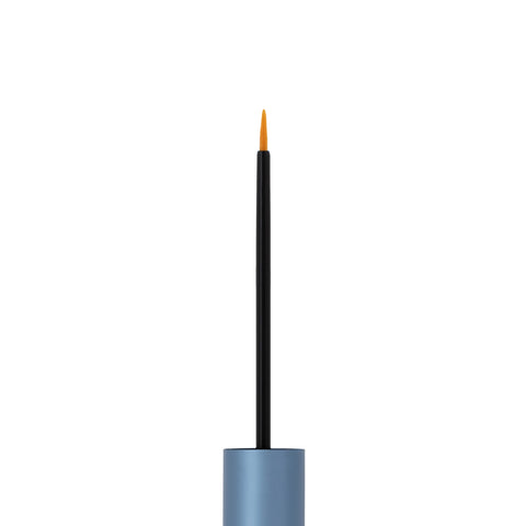 The image shows a close-up of the RevitaLash Advanced Eyelash Conditioner and Enhancing Serum Sensitive, featuring a thin black-handled brush with a fine tip emerging from a metallic blue cylindrical cap infused with peptides and botanicals, set against a plain white background.