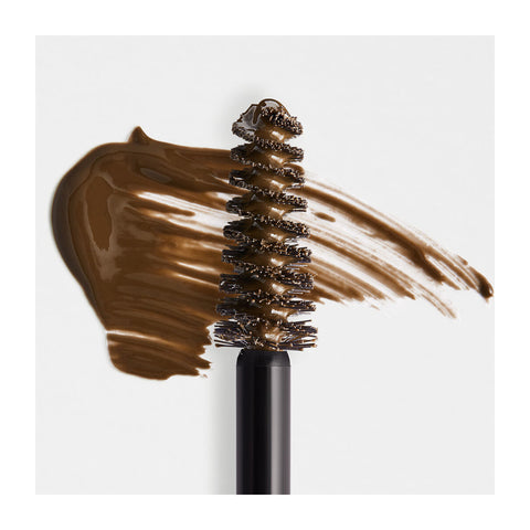 The RevitaLash Hi-Def Brow Gel in Soft Brown features a mascara wand and bold brushstroke background. SOFT BROWN text is in the top right corner. Achieve flawless arches with our precision styling brush, ideal for lashes and brows. Available in 3 colors by RevitaLash.