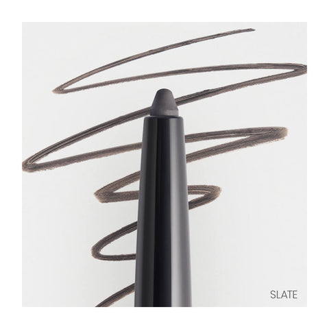 A RevitaLash Defining Liner Eyeliner in black, with its tip extended, creates curvy lines on a white background. The word SLATE appears in the bottom right, indicating smudge-proof precision for flawless wear.