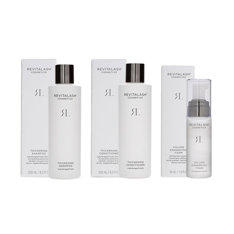 RevitaLash offers the Volumizing Hair Collection Bundle, featuring the Shampoo, Conditioner, and Foam. Each product is elegantly packaged in sleek white boxes with black and silver accents.