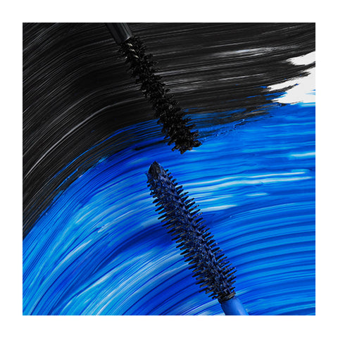 Two mascara wands against bold blue and black brush strokes on canvas. The top wand with RevitaLash Double-Ended 2-in-1 Lash Primer & Mascara Volume Set primer blends into black paint, while the bottom wands mascara with blue bristles blends into blue paint.