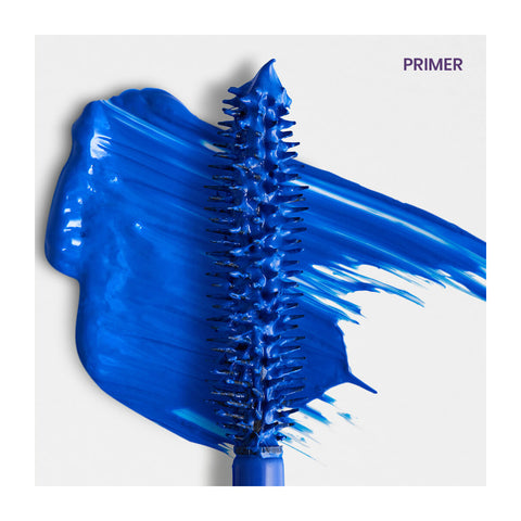 A vivid blue RevitaLash Double-Ended 2-in-1 Lash Primer & Mascara Volume Set wand is on a white background, surrounded by bold blue strokes. PRIMER is elegantly scripted in the top right corner.