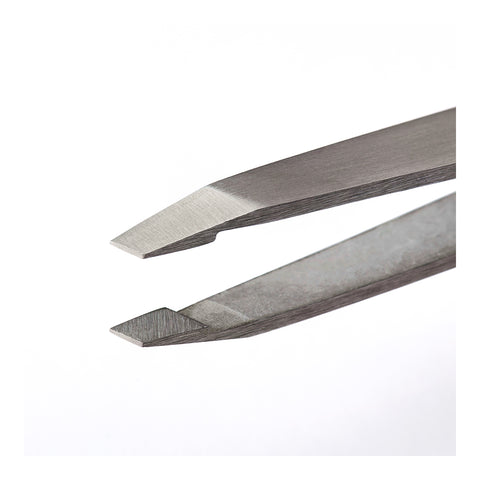 Close-up of RevitaLash Precision Tweezer by RevitaLash, featuring a sharp, angled tip against a white background. This sleek, professional-grade tool is precision-crafted for detailed tasks like electronics or crafts.